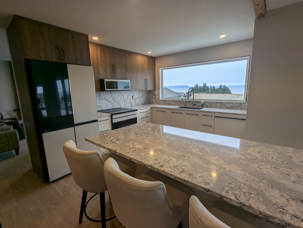 Kitchen interior featuring sink, cabinetry, and scenic ocean view through window