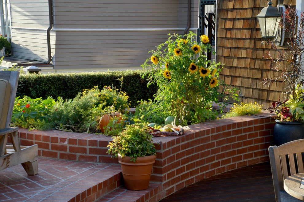 This is an example of a mid-sized traditional backyard patio in San Diego with a vegetable garden and brick pavers.