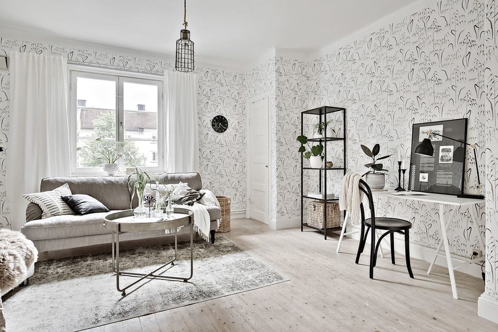 Mid-sized scandinavian formal open concept living room in Gothenburg with multi-coloured walls, light hardwood floors and no tv.