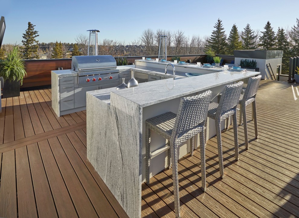 Design ideas for a large contemporary deck in Edmonton with with fireplace and no cover.