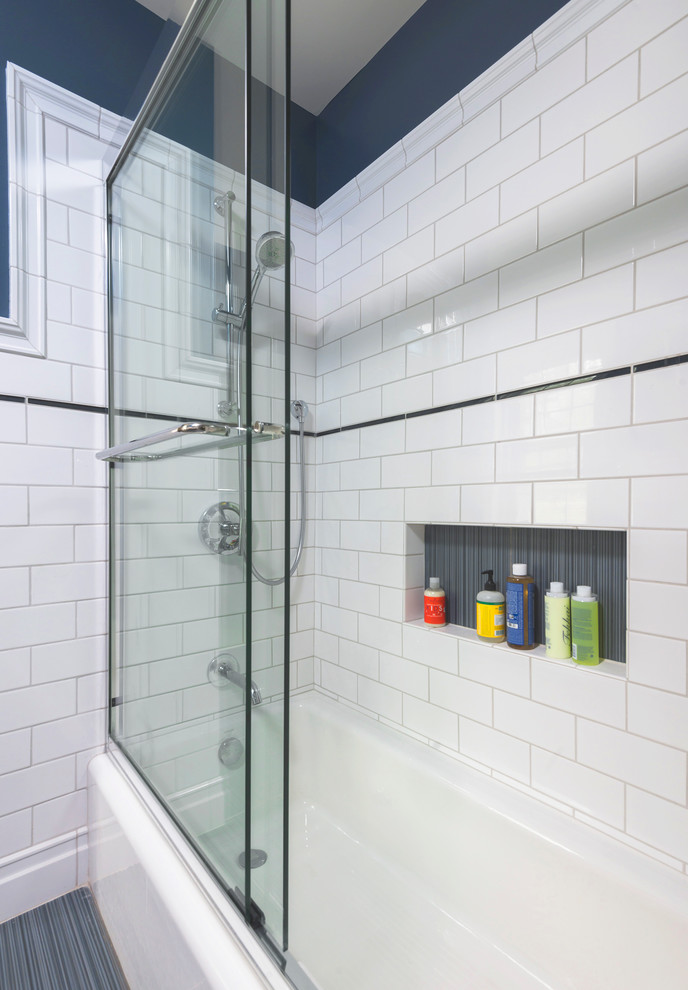 Alcove bathtub - mid-sized transitional kids' white tile and ceramic tile porcelain tile alcove bathtub idea in Philadelphia with a wall-mount sink, flat-panel cabinets, medium tone wood cabinets, a one-piece toilet and blue walls