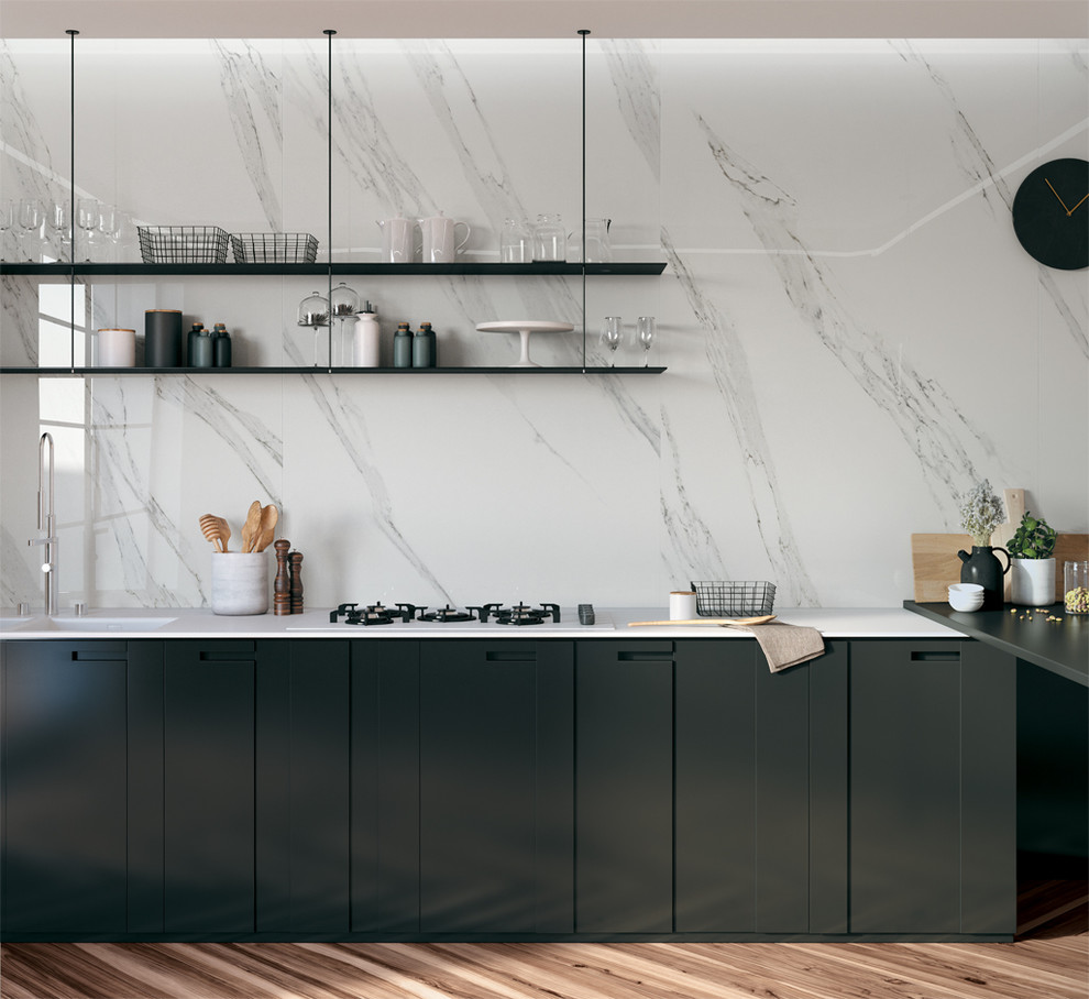 This is an example of a contemporary l-shaped kitchen in Perth with flat-panel cabinets, black cabinets, solid surface benchtops, white splashback, porcelain splashback, a peninsula and a double-bowl sink.