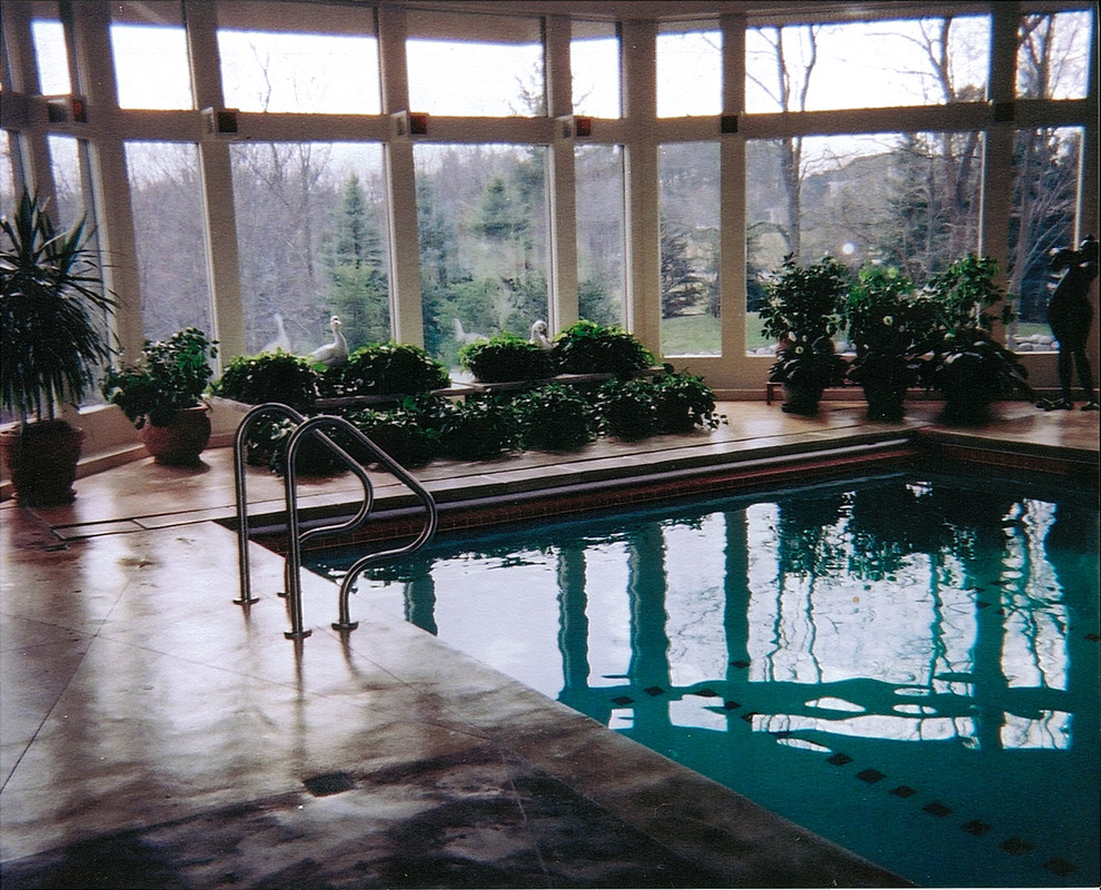 This is an example of a mid-sized transitional indoor rectangular lap pool in Detroit with concrete slab.
