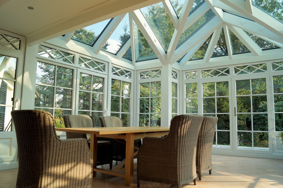 Großer Klassischer Wintergarten mit dunklem Holzboden, Kaminofen, Oberlicht und braunem Boden in Hamburg