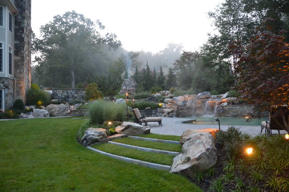 Inspiration for a mid-sized rustic backyard concrete paver and custom-shaped lap pool fountain remodel in DC Metro