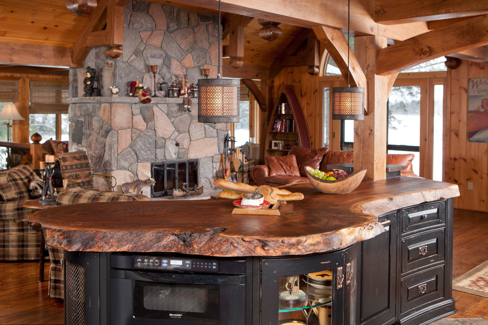 Eat-in kitchen - mid-sized rustic u-shaped medium tone wood floor eat-in kitchen idea in Toronto with raised-panel cabinets, distressed cabinets, granite countertops, paneled appliances and an island