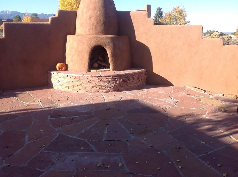 Inspiration for a mid-sized backyard patio in Albuquerque with an outdoor kitchen, natural stone pavers and no cover.