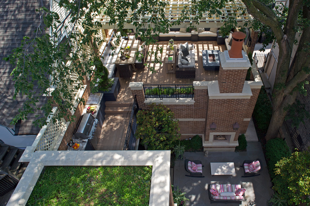This is an example of an expansive traditional rooftop deck in Chicago with a pergola.