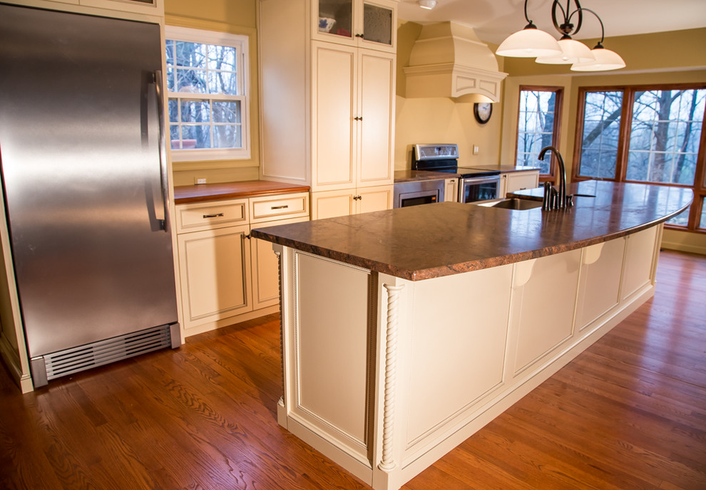 Inspiration for a traditional single-wall kitchen in Baltimore with an undermount sink, recessed-panel cabinets, white cabinets, granite benchtops, stainless steel appliances, medium hardwood floors and with island.