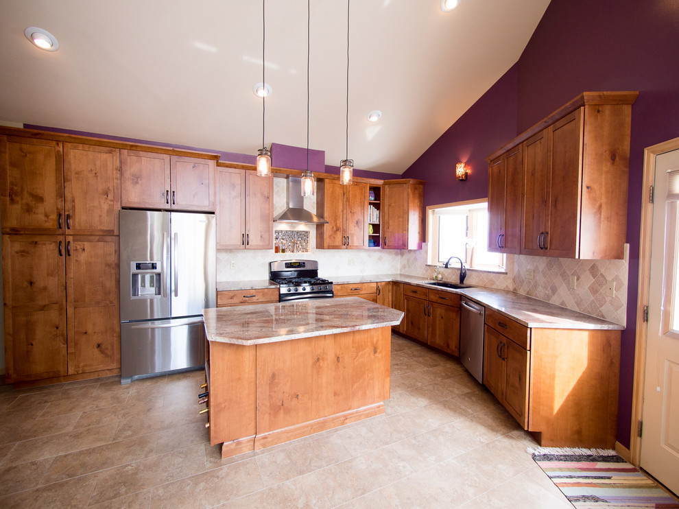 Open concept kitchen - large craftsman l-shaped ceramic tile and beige floor open concept kitchen idea in Denver with an undermount sink, shaker cabinets, medium tone wood cabinets, granite countertops, beige backsplash, ceramic backsplash, stainless steel appliances and an island