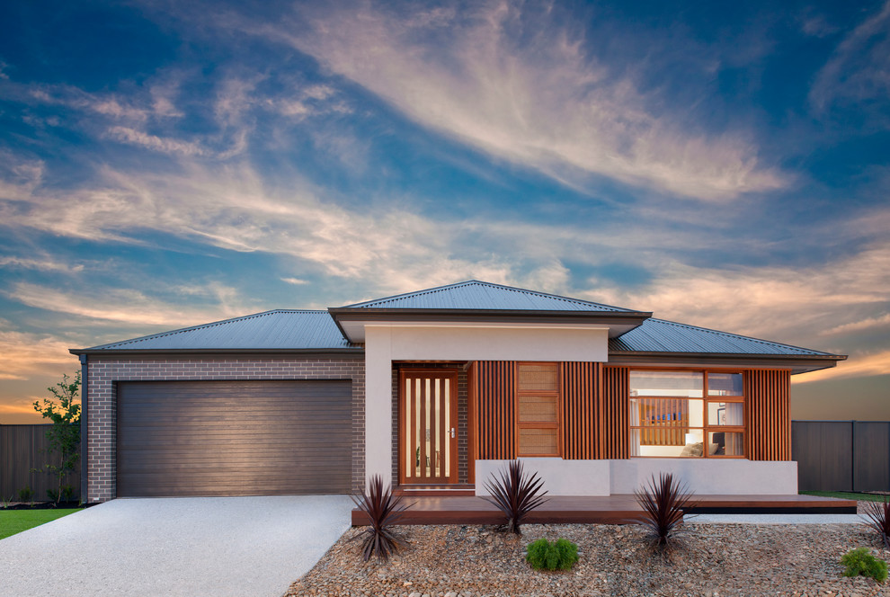 This is an example of a contemporary one-storey exterior in Melbourne with mixed siding and a hip roof.