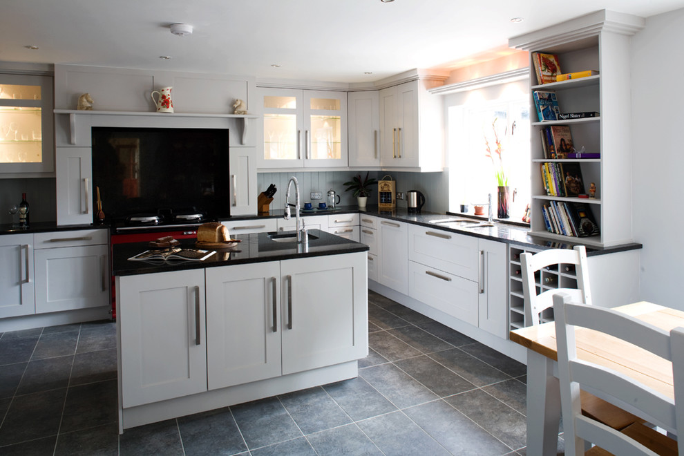 Photo of a transitional l-shaped kitchen in Other with shaker cabinets and white cabinets.