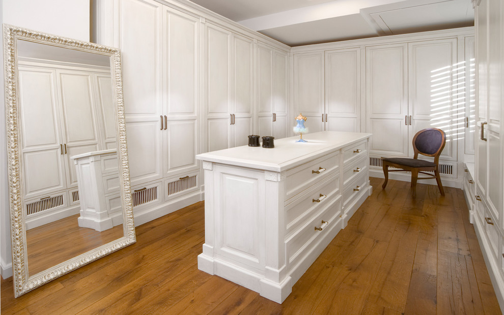 This is an example of a contemporary dressing room in Other with white cabinets.