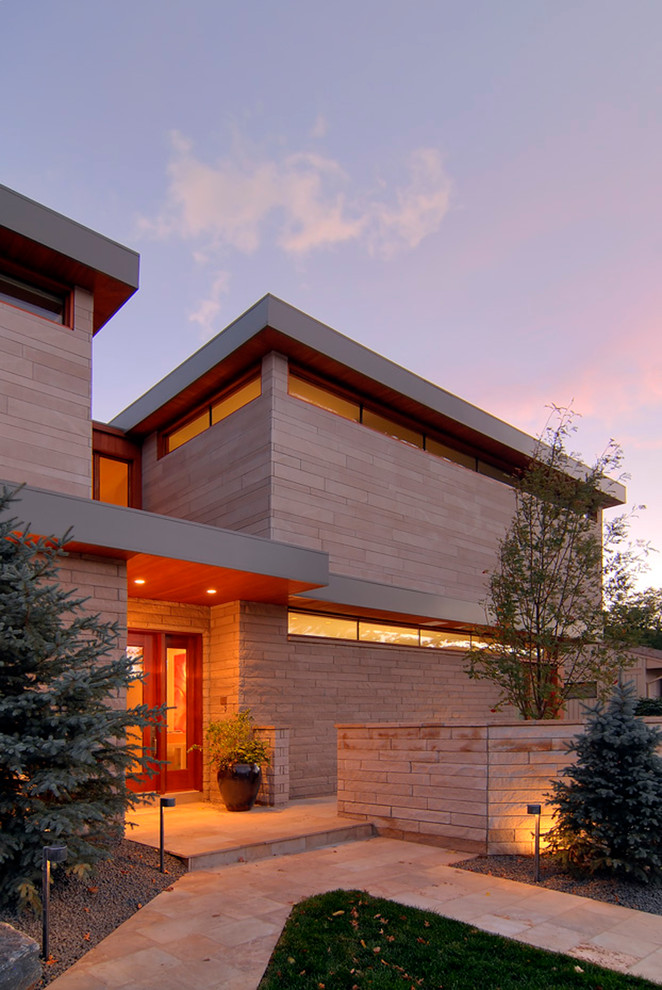 Photo of a large contemporary two-storey beige house exterior in Denver with mixed siding and a shed roof.