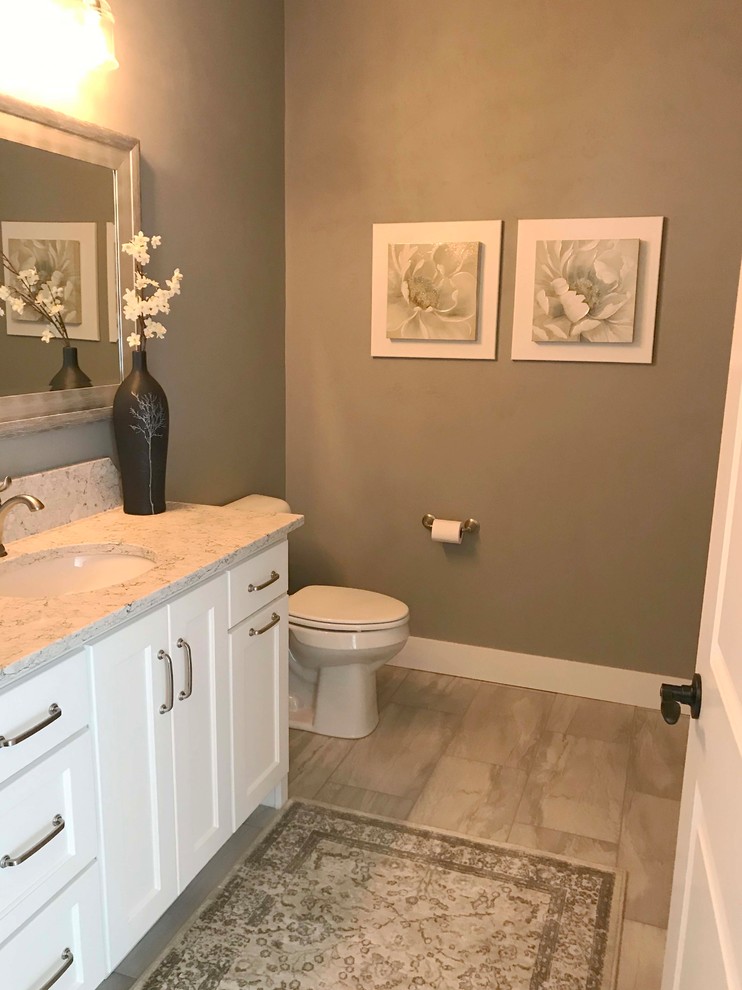 Design ideas for a mid-sized arts and crafts 3/4 bathroom in Other with shaker cabinets, white cabinets, a one-piece toilet, beige walls, porcelain floors, an undermount sink, granite benchtops and beige floor.