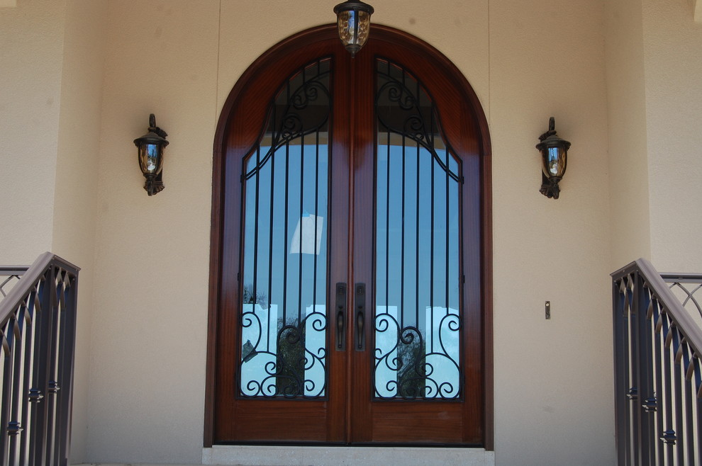 Inspiration for a large rustic front door remodel in Miami with beige walls and a dark wood front door