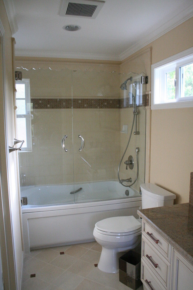 Transitional bathroom in San Francisco with recessed-panel cabinets, beige cabinets, granite benchtops, a freestanding tub, a shower/bathtub combo, a two-piece toilet, brown tile and ceramic tile.