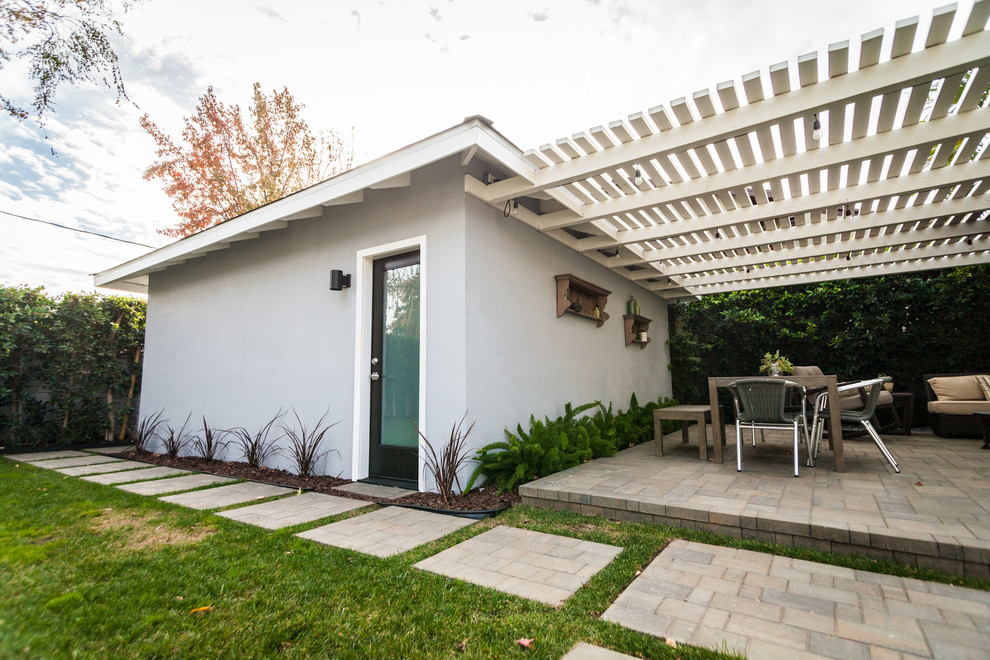 Inspiration for a transitional patio in Los Angeles with concrete pavers and a pergola.
