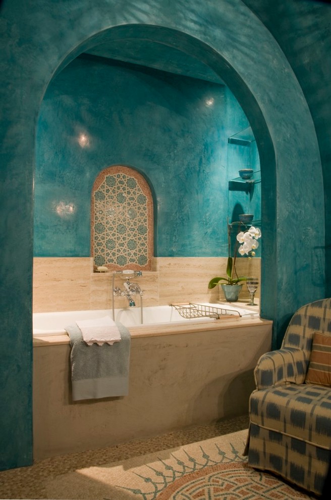 Photo of a mid-sized mediterranean 3/4 bathroom in London with a drop-in tub, multi-coloured tile, blue walls, ceramic tile and mosaic tile floors.