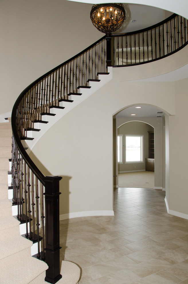 Design ideas for a traditional wood curved staircase in Omaha with wood risers.