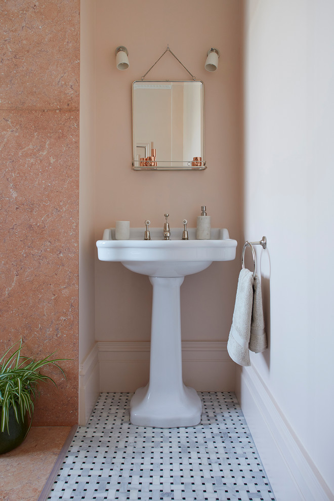 Design ideas for a large traditional kids bathroom in London with furniture-like cabinets, dark wood cabinets, a freestanding tub, an open shower, a two-piece toilet, pink tile, marble, pink walls, mosaic tile floors, a pedestal sink, black floor and an open shower.