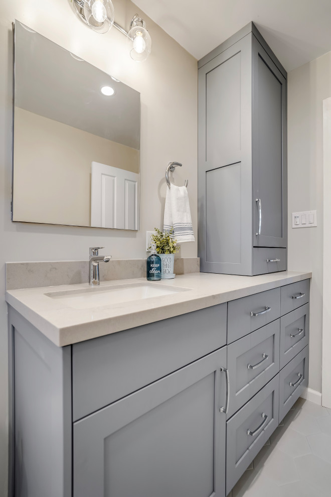 This is an example of a mid-sized transitional bathroom in San Francisco with shaker cabinets, blue cabinets, an alcove shower, blue tile, glass sheet wall, grey walls, porcelain floors, an undermount sink, engineered quartz benchtops, grey floor, a hinged shower door, grey benchtops, a single vanity and a built-in vanity.