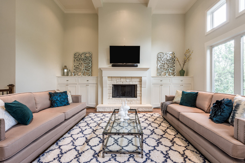 Photo of a large transitional formal open concept living room in Austin with beige walls, dark hardwood floors, a standard fireplace, a stone fireplace surround, a wall-mounted tv and brown floor.