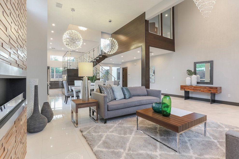 Inspiration for a large contemporary formal open concept living room in Sacramento with white walls, porcelain floors, a ribbon fireplace, a stone fireplace surround, no tv and white floor.