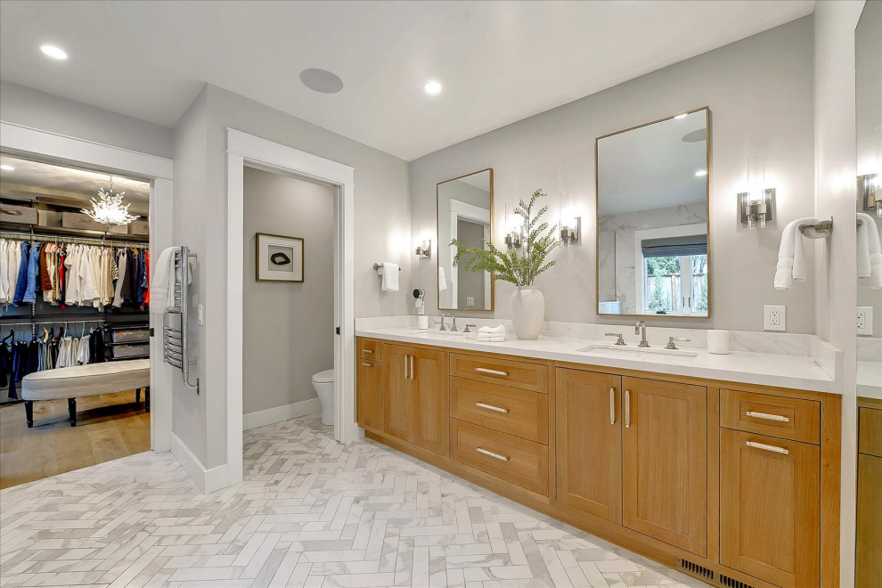 Photo of a mid-sized arts and crafts master bathroom in San Francisco with grey walls, medium hardwood floors, brown floor, shaker cabinets, brown cabinets, a freestanding tub, a corner shower, a one-piece toilet, an undermount sink, engineered quartz benchtops, white benchtops, an enclosed toilet, a double vanity and a built-in vanity.