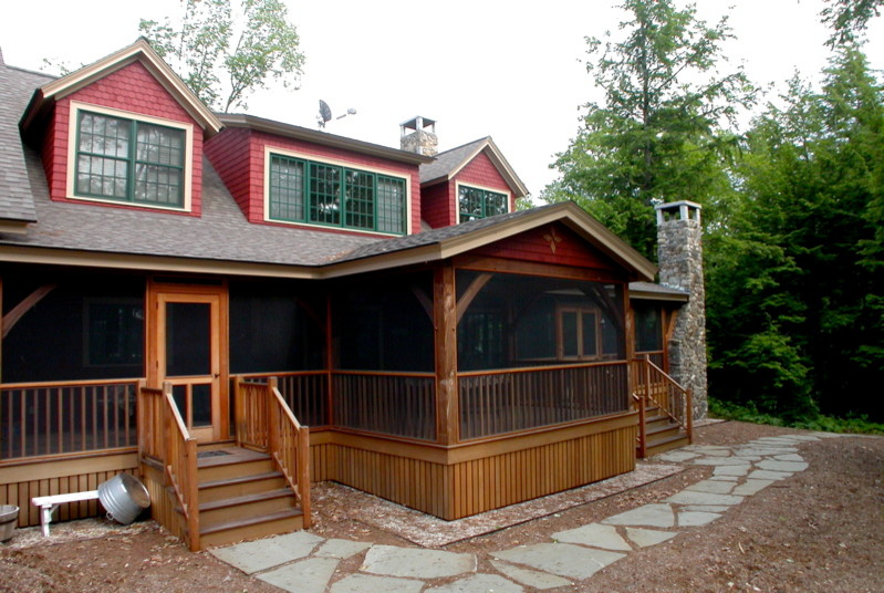 This is an example of a large traditional two-storey red exterior in Portland Maine with wood siding.