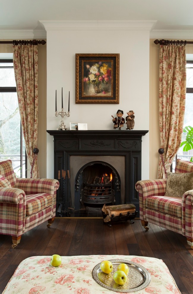Design ideas for a traditional living room in Moscow with beige walls, dark hardwood floors and a standard fireplace.