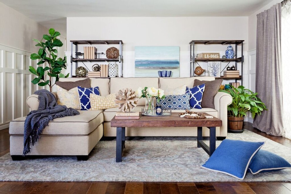 This is an example of a mid-sized beach style open concept living room in Los Angeles with beige walls, medium hardwood floors and a wall-mounted tv.