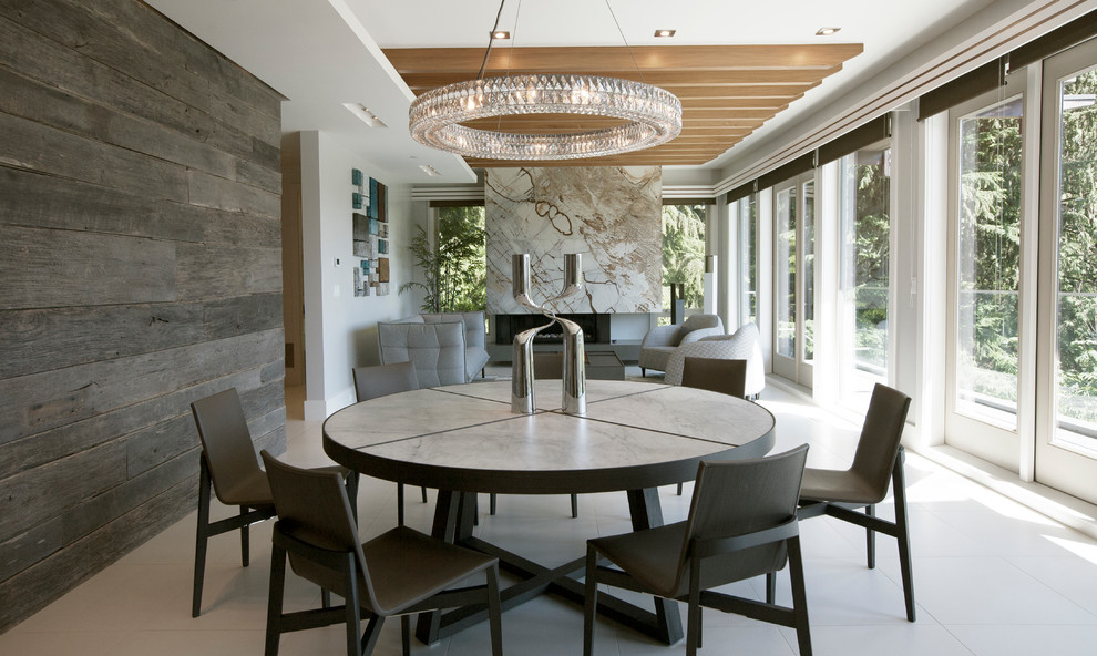 This is an example of a contemporary open plan dining in Vancouver with brown walls, a ribbon fireplace, a stone fireplace surround and white floor.