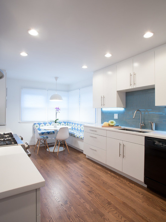 Mid-sized modern galley eat-in kitchen in Chicago with an undermount sink, flat-panel cabinets, white cabinets, copper benchtops, blue splashback, subway tile splashback, stainless steel appliances, medium hardwood floors and no island.