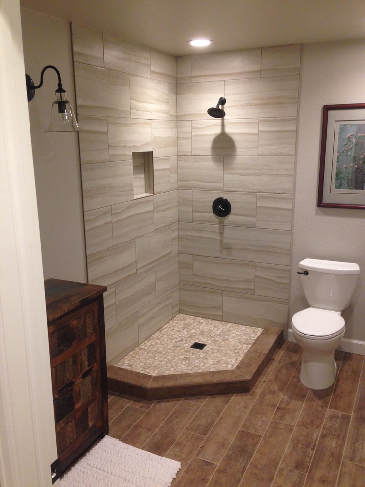 Large contemporary 3/4 bathroom in Denver with a vessel sink, furniture-like cabinets, distressed cabinets, wood benchtops, a corner shower, beige tile, porcelain tile, grey walls and porcelain floors.