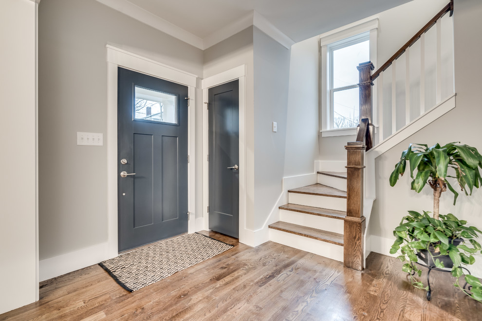 Mid-sized arts and crafts foyer in Raleigh with grey walls, medium hardwood floors, a single front door and a blue front door.