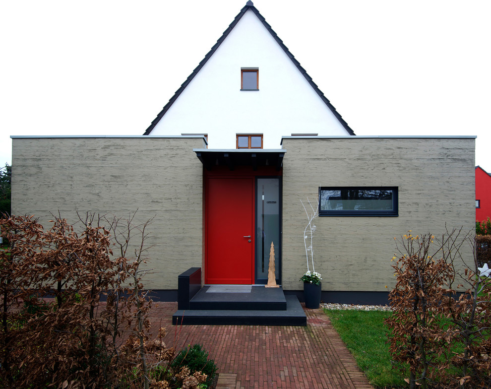 Inspiration for a small contemporary one-storey duplex exterior in Dusseldorf with wood siding, a flat roof and a green roof.