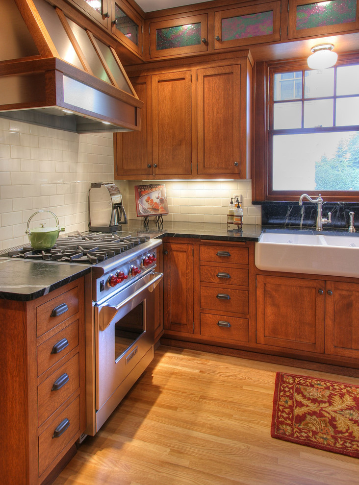 Arts and crafts kitchen in Minneapolis with stainless steel appliances, a farmhouse sink and soapstone benchtops.