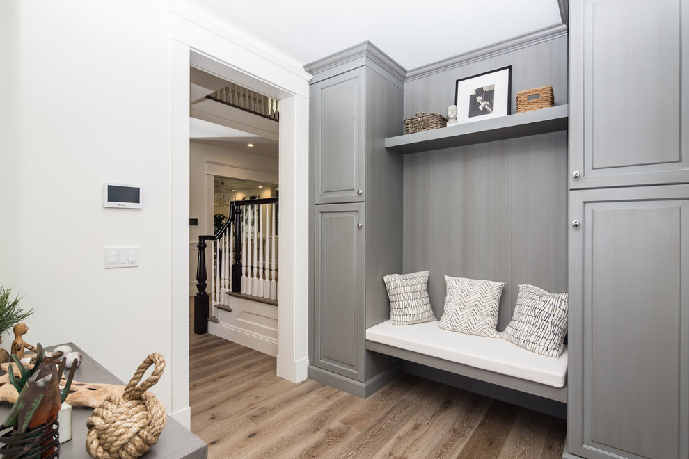 Beach style mudroom in Los Angeles with white walls and dark hardwood floors.