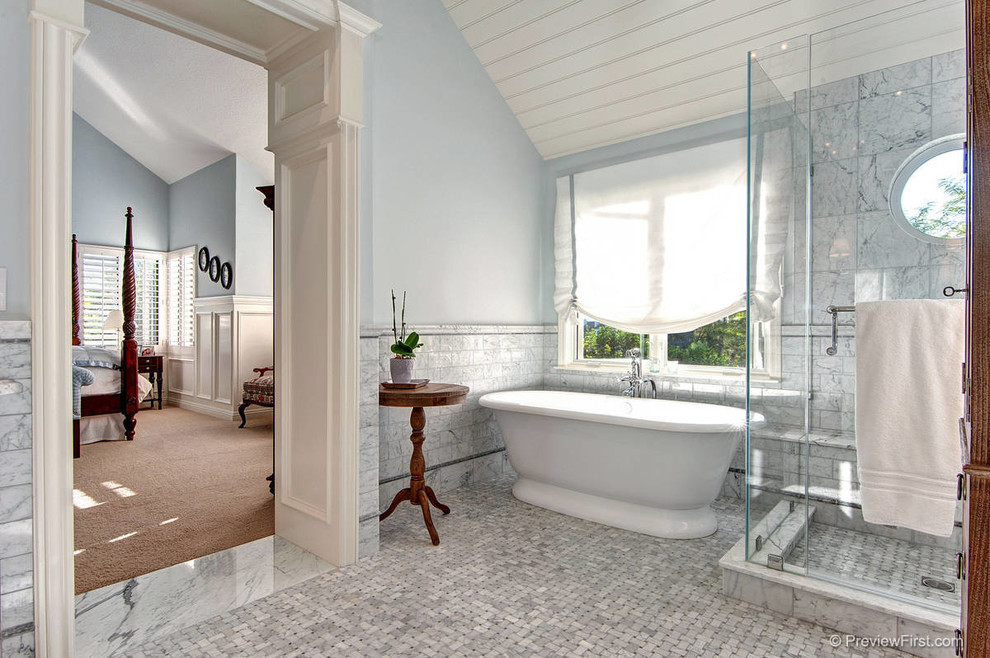 This is an example of a beach style bathroom in Orange County with a freestanding tub and an alcove shower.