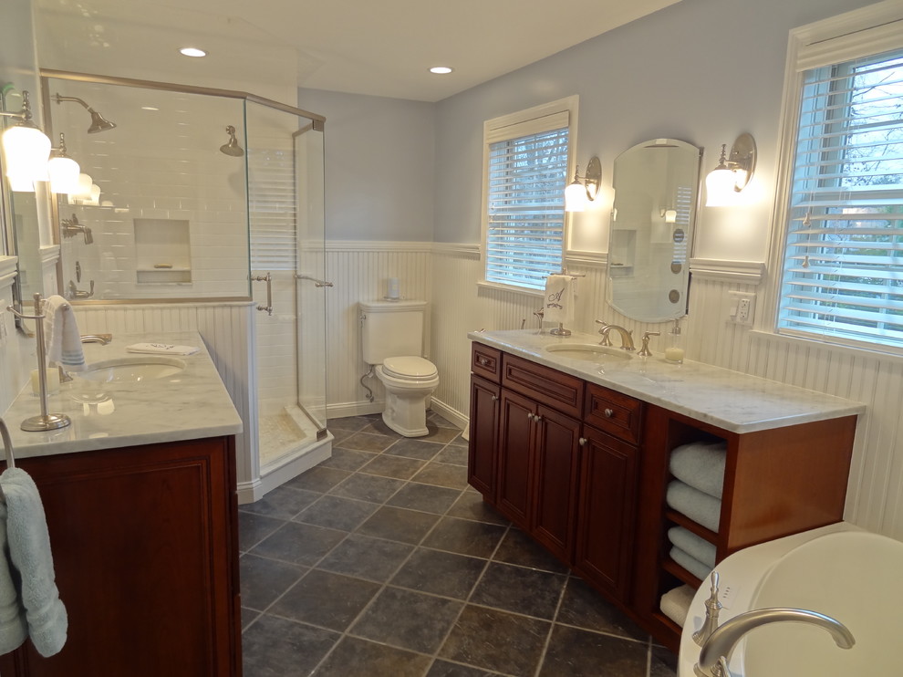 Photo of a large contemporary master bathroom in Boston with an undermount sink, beaded inset cabinets, medium wood cabinets, marble benchtops, a corner shower, a two-piece toilet, blue walls and porcelain floors.