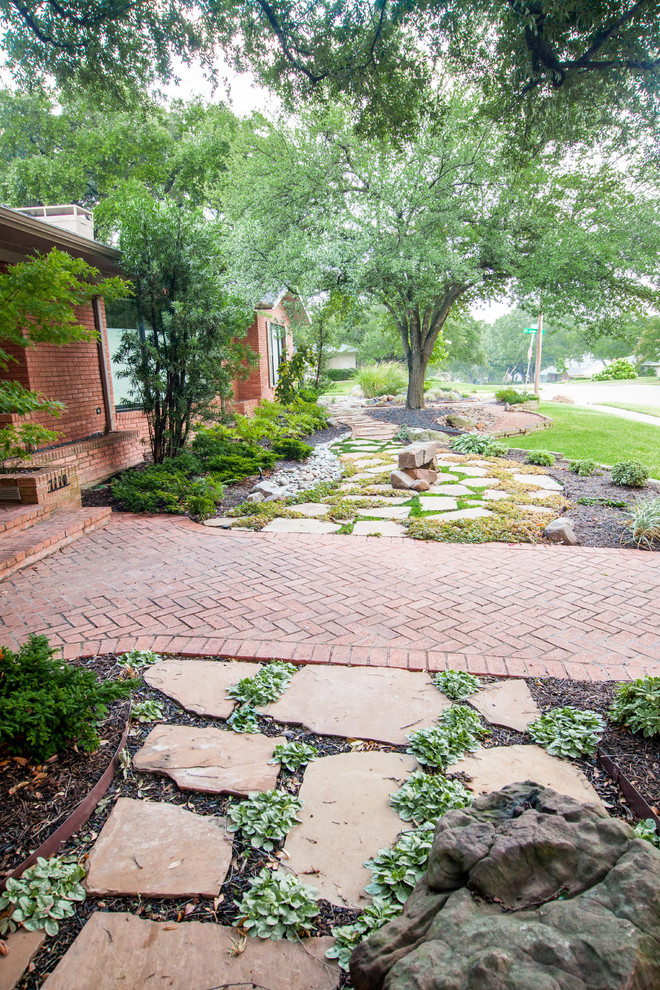 Photo of a large southwestern shade front yard stone formal garden in Dallas.