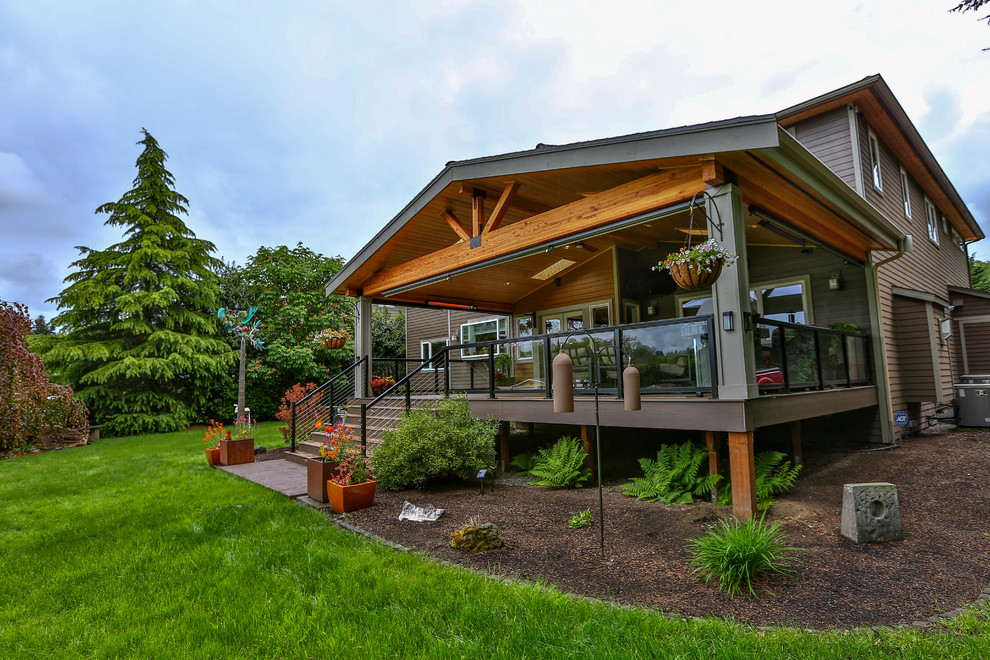 Design ideas for a large modern backyard deck in Seattle with a roof extension and an outdoor kitchen.