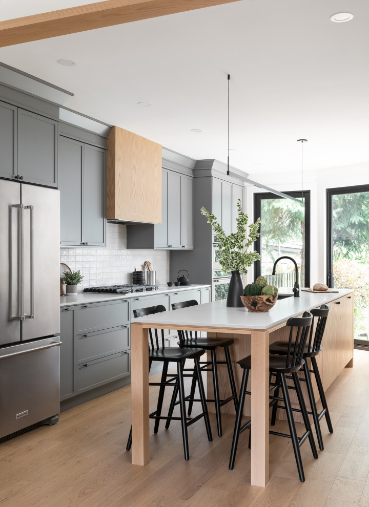 This is an example of a transitional single-wall kitchen in Toronto with shaker cabinets and with island.