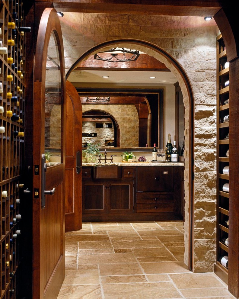 Design ideas for an expansive traditional wine cellar in Boston with storage racks and travertine floors.