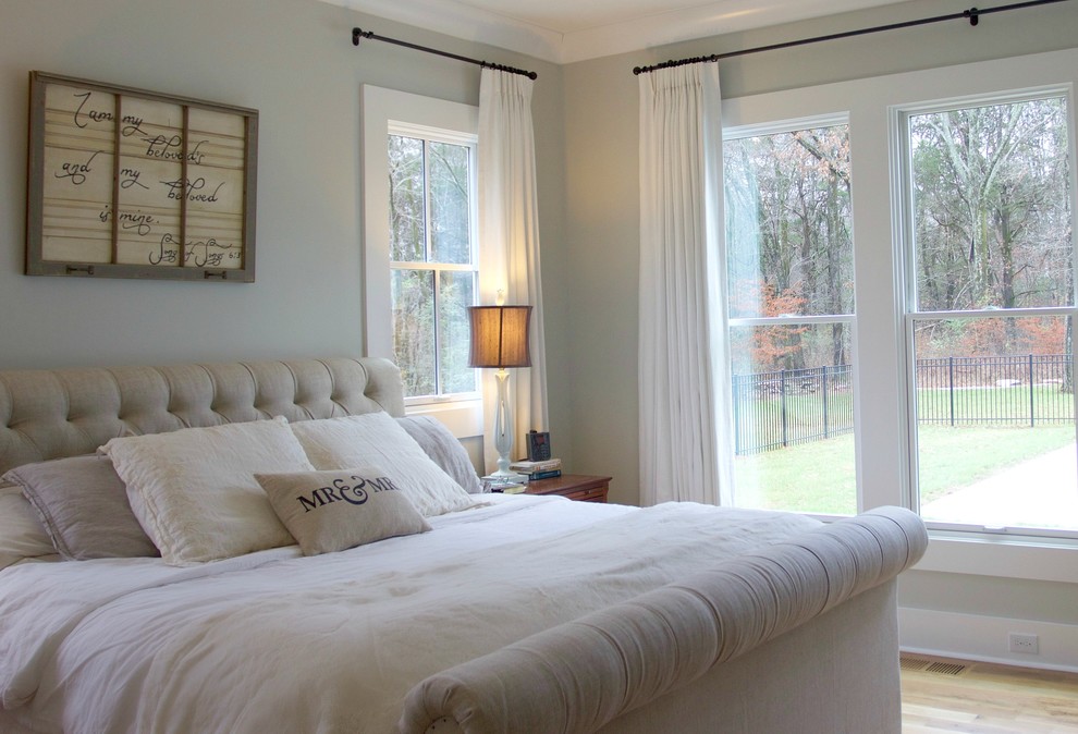 Inspiration for a mid-sized country master bedroom in Nashville with grey walls, light hardwood floors, no fireplace and brown floor.