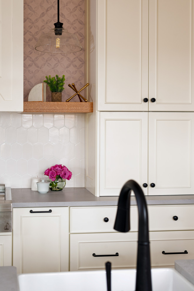 Eat-in kitchen - large medium tone wood floor and exposed beam eat-in kitchen idea with white backsplash, stainless steel appliances and an island