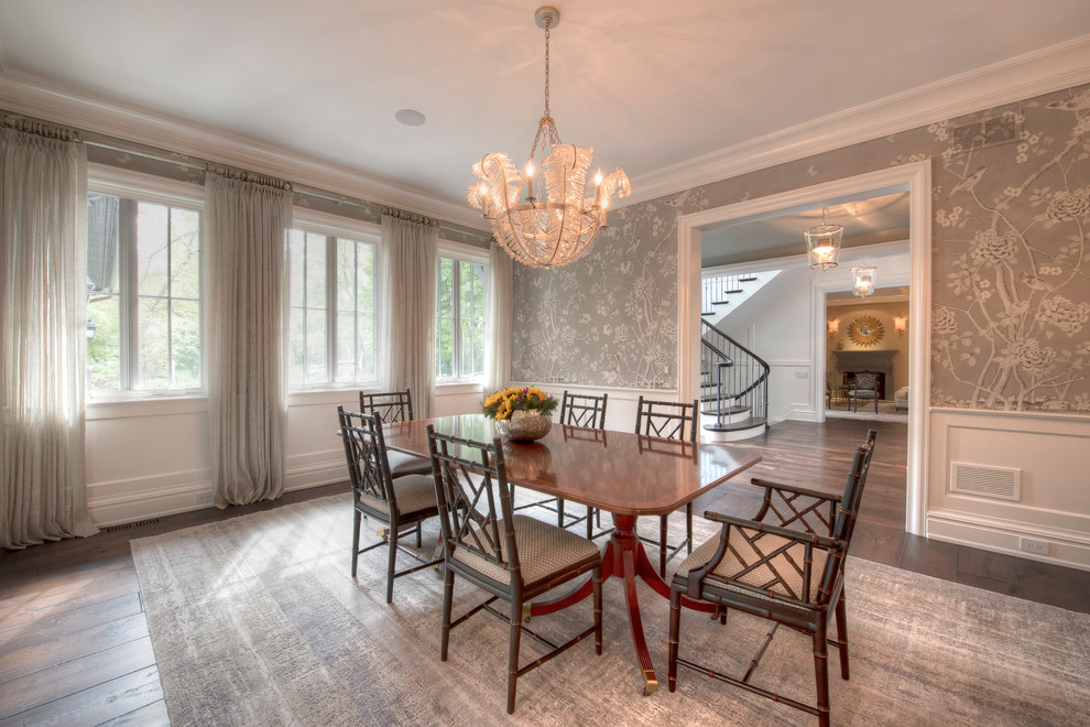 Large transitional medium tone wood floor and brown floor enclosed dining room photo with multicolored walls and no fireplace