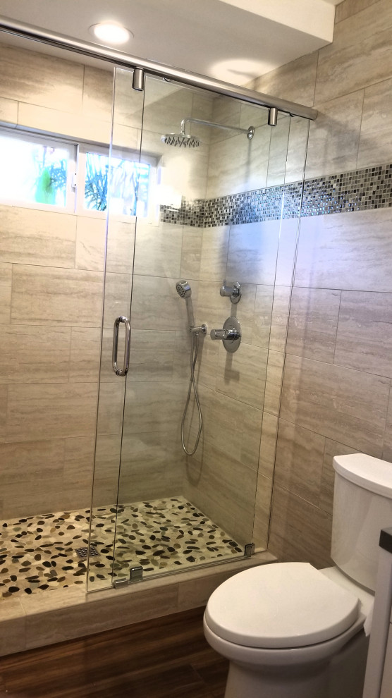 Inspiration for a medium sized contemporary ensuite bathroom in Orange County with shaker cabinets, white cabinets, an alcove shower, a two-piece toilet, beige tiles, metro tiles, beige walls, porcelain flooring, a vessel sink, quartz worktops, brown floors, a sliding door, brown worktops, a single sink and a freestanding vanity unit.