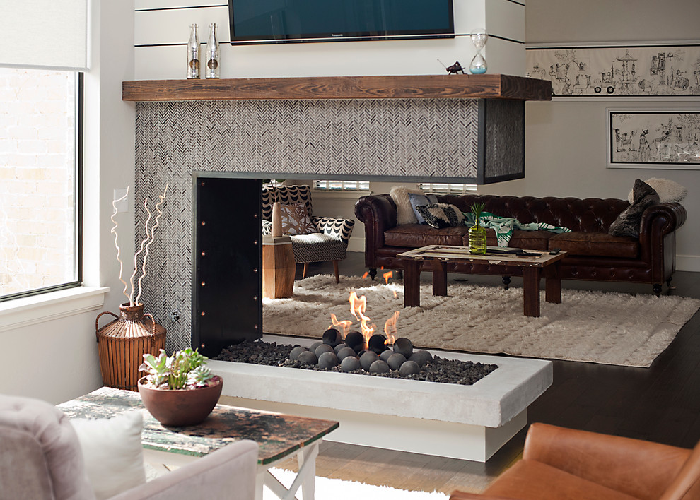 This is an example of a mid-sized modern open concept living room in Oklahoma City with a two-sided fireplace, a tile fireplace surround, white walls, dark hardwood floors and a wall-mounted tv.